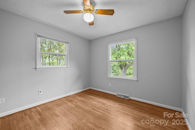 20 Summit Dr, Arden, NC 28704 - unfurnished room with plenty of natural light, wood finished floors, and ceiling fan