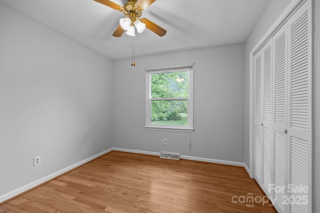 20 Summit Dr, Arden, NC 28704 - unfurnished bedroom featuring light wood finished floors, a closet, and ceiling fan