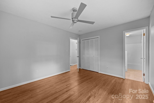 20 Summit Dr, Arden, NC 28704 - unfurnished bedroom featuring wood finished floors, a closet, connected bathroom, and ceiling fan