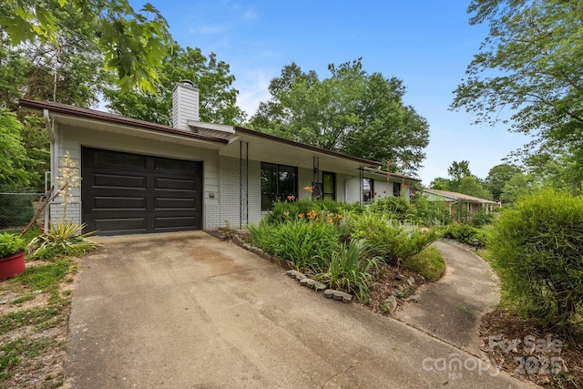 20 Summit Dr, Arden, NC 28704 - ranch-style house with concrete driveway, a chimney, an attached garage, and brick siding