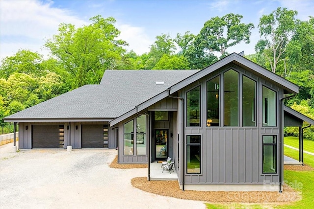 3304 Mar Vista Cir, Charlotte, NC 28209 - view of front of house with board and batten siding, driveway, and an attached garage