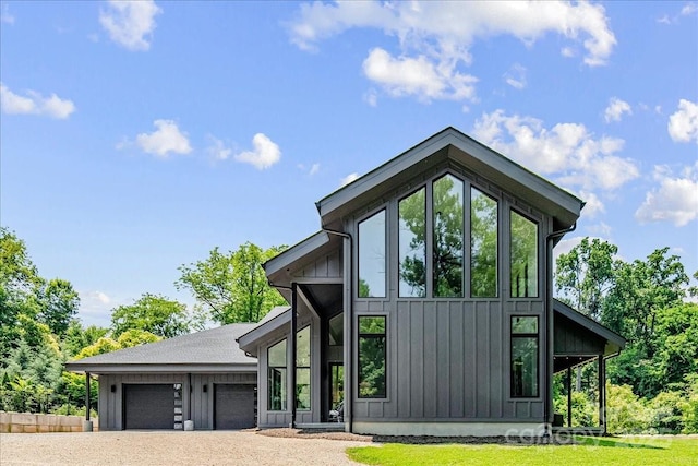 3304 Mar Vista Cir, Charlotte, NC 28209 - view of front facade featuring board and batten siding, an attached garage, dirt driveway, and a front yard