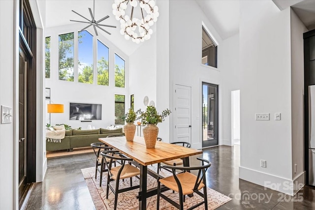 3304 Mar Vista Cir, Charlotte, NC 28209 - dining area featuring a towering ceiling, finished concrete flooring, and a chandelier