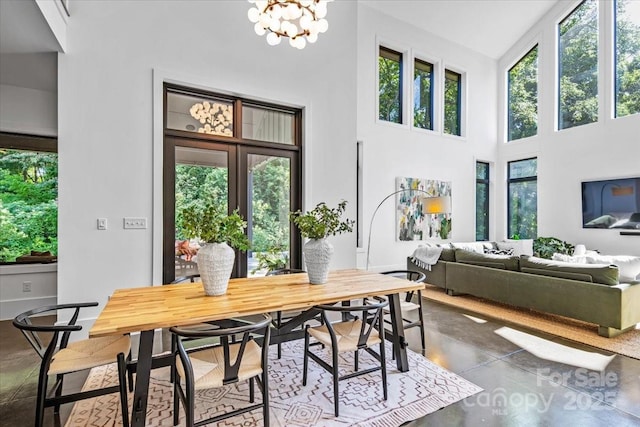 3304 Mar Vista Cir, Charlotte, NC 28209 - dining room featuring finished concrete flooring, a high ceiling, and a chandelier