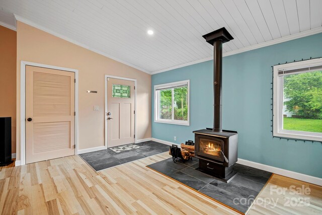419 E Blue Ridge Rd, East Flat Rock, NC 28726 - foyer with a wood stove, crown molding, wood finished floors, lofted ceiling, and wood ceiling