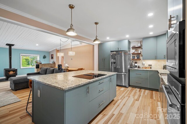 419 E Blue Ridge Rd, East Flat Rock, NC 28726 - kitchen featuring stainless steel appliances, light wood-style floors, a center island, tasteful backsplash, and crown molding