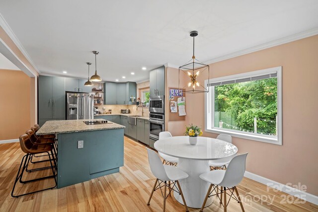 419 E Blue Ridge Rd, East Flat Rock, NC 28726 - kitchen with stainless steel appliances, gray cabinetry, a center island, tasteful backsplash, and ornamental molding