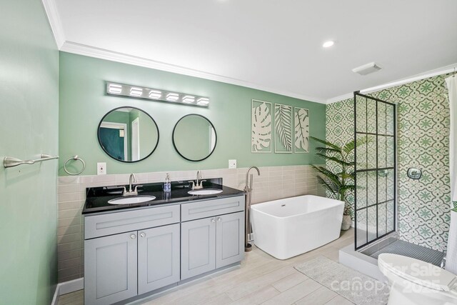 419 E Blue Ridge Rd, East Flat Rock, NC 28726 - full bath with tile walls, ornamental molding, double vanity, a shower stall, and a soaking tub