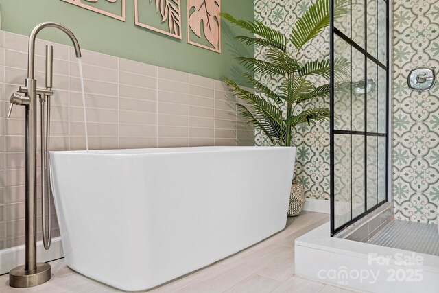 419 E Blue Ridge Rd, East Flat Rock, NC 28726 - bathroom featuring tile walls and a soaking tub