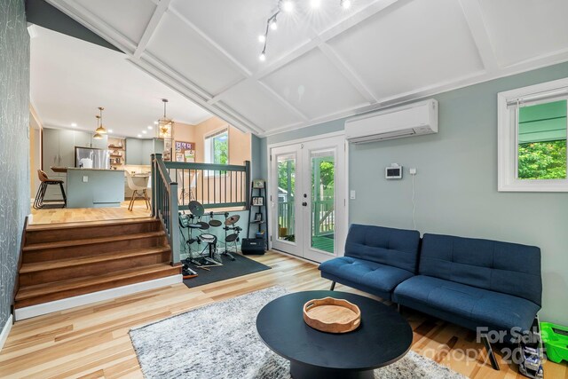 419 E Blue Ridge Rd, East Flat Rock, NC 28726 - living area featuring a wall mounted AC, wood finished floors, and stairway