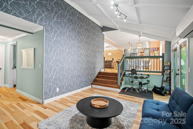 419 E Blue Ridge Rd, East Flat Rock, NC 28726 - living area with wallpapered walls, wood finished floors, stairs, a wall mounted air conditioner, and an accent wall
