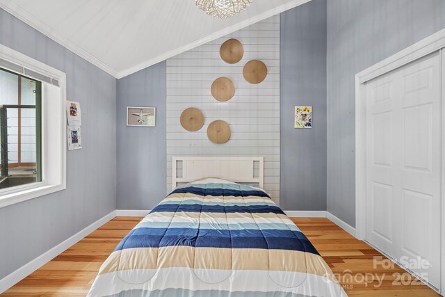 419 E Blue Ridge Rd, East Flat Rock, NC 28726 - bedroom featuring vaulted ceiling, light wood-style floors, and ornamental molding