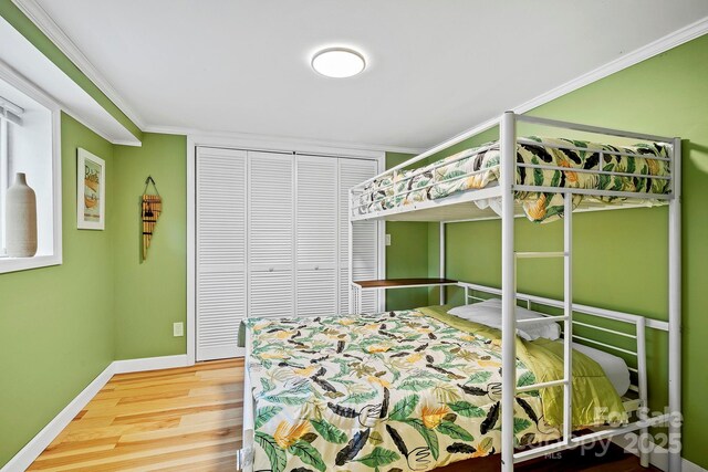 419 E Blue Ridge Rd, East Flat Rock, NC 28726 - bedroom with wood finished floors, crown molding, and a closet