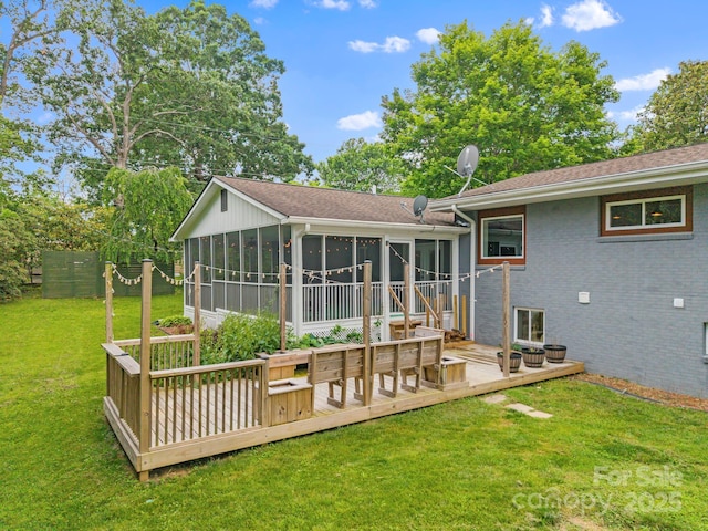 419 E Blue Ridge Rd, East Flat Rock, NC 28726 - rear view of house with a sunroom, a deck, brick siding, and roof with shingles