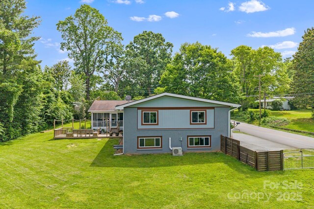 419 E Blue Ridge Rd, East Flat Rock, NC 28726 - rear view of property featuring a sunroom and view of wooded area