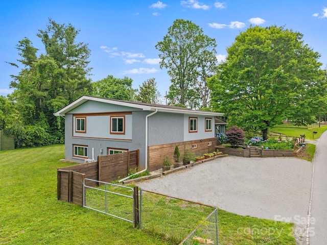 419 E Blue Ridge Rd, East Flat Rock, NC 28726 - rear view of property featuring a garden and stucco siding