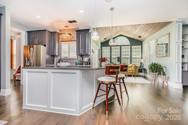 10203 Loch Lomond Dr, Charlotte, NC 28278 - kitchen with stainless steel fridge with ice dispenser, dark countertops, healthy amount of natural light, hanging light fixtures, and lofted ceiling
