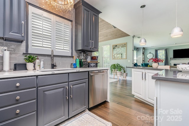 10203 Loch Lomond Dr, Charlotte, NC 28278 - kitchen with dishwasher, dark wood finished floors, tasteful backsplash, gray cabinets, and hanging light fixtures
