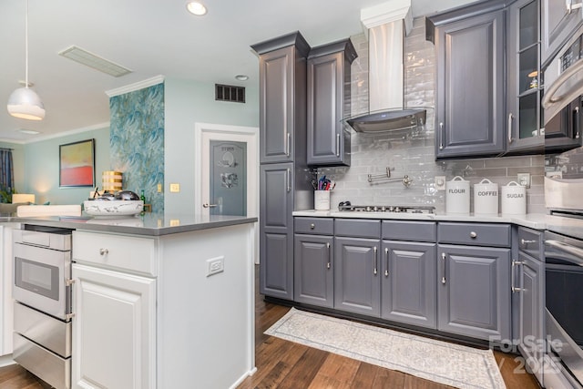 10203 Loch Lomond Dr, Charlotte, NC 28278 - kitchen featuring wall chimney range hood, gray cabinets, oven, dark wood-style floors, and decorative backsplash