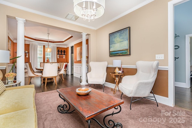 10203 Loch Lomond Dr, Charlotte, NC 28278 - living area featuring ornate columns, ornamental molding, wood finished floors, a chandelier, and a raised ceiling