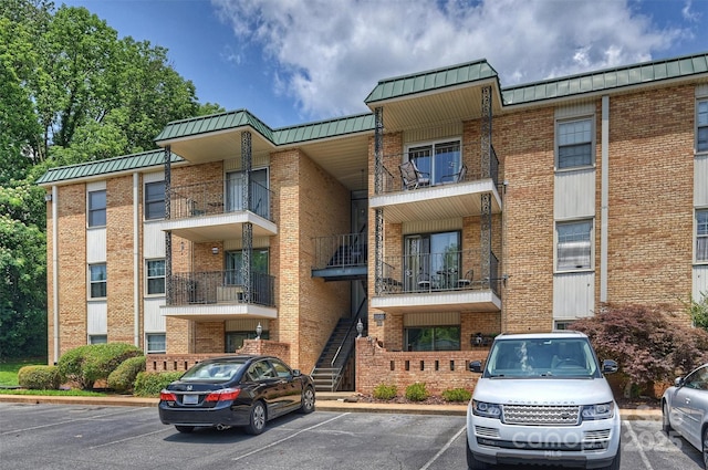 4736 Hedgemore Dr Unit K, Charlotte, NC 28209 - view of apartment building / complex featuring uncovered parking and stairs