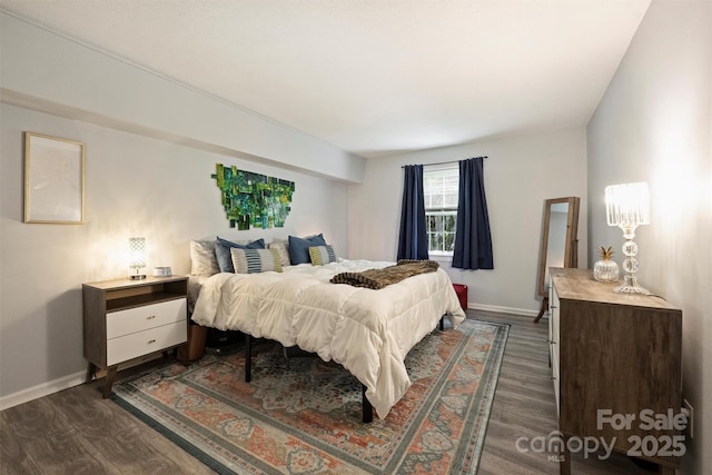 4736 Hedgemore Dr Unit K, Charlotte, NC 28209 - bedroom featuring dark wood-style floors and baseboards