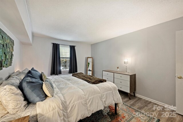 4736 Hedgemore Dr Unit K, Charlotte, NC 28209 - bedroom with wood finished floors and a textured ceiling