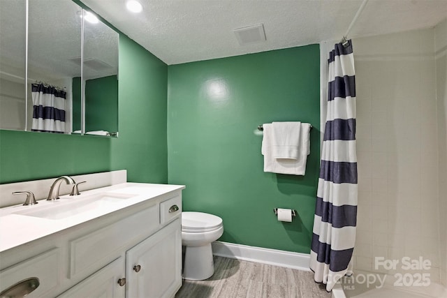 4736 Hedgemore Dr Unit K, Charlotte, NC 28209 - full bath featuring vanity, a tile shower, wood finished floors, and a textured ceiling