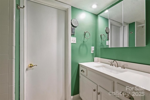 4736 Hedgemore Dr Unit K, Charlotte, NC 28209 - bathroom with vanity and a textured ceiling