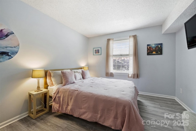 4736 Hedgemore Dr Unit K, Charlotte, NC 28209 - bedroom featuring a textured ceiling and wood finished floors