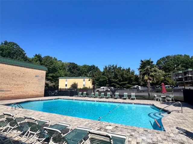 4736 Hedgemore Dr Unit K, Charlotte, NC 28209 - community pool with a patio and view of scattered trees