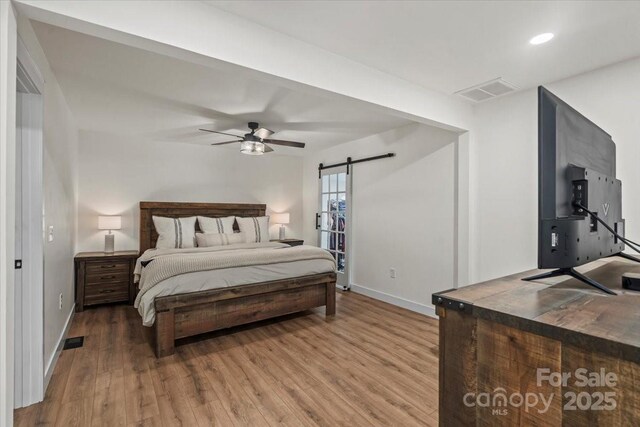 5740 Crouse Rd, Crouse, NC 28033 - bedroom featuring a barn door, wood finished floors, recessed lighting, and a ceiling fan
