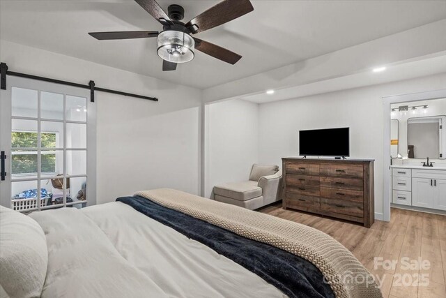 5740 Crouse Rd, Crouse, NC 28033 - bedroom featuring light wood finished floors, a barn door, recessed lighting, ensuite bathroom, and a ceiling fan