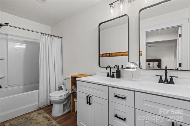 5740 Crouse Rd, Crouse, NC 28033 - bathroom featuring double vanity, wood finished floors, and shower / bath combo with shower curtain