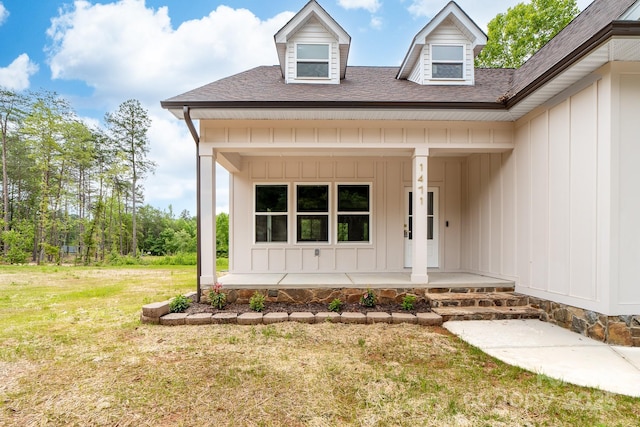 1471 Marshbrooke Ln, Catawba, NC 28609 - doorway to property with covered porch, a lawn, board and batten siding, and a shingled roof