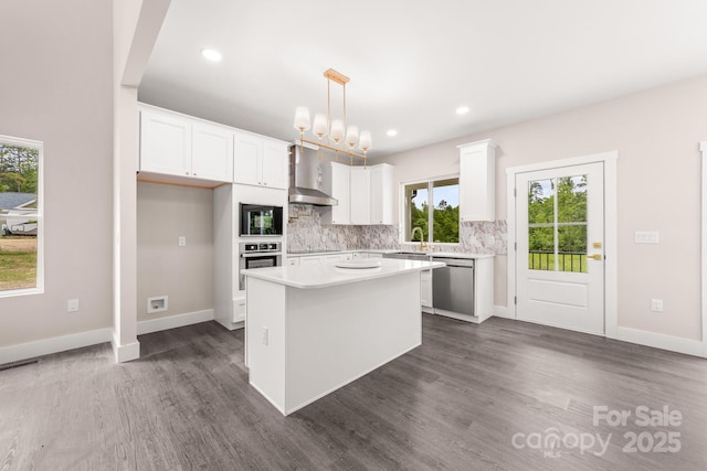 1471 Marshbrooke Ln, Catawba, NC 28609 - kitchen with wall chimney range hood, stainless steel appliances, plenty of natural light, dark wood-style flooring, and recessed lighting