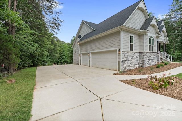 8283 Long Island Rd, Catawba, NC 28609 - view of property exterior featuring stone siding, concrete driveway, and a shingled roof