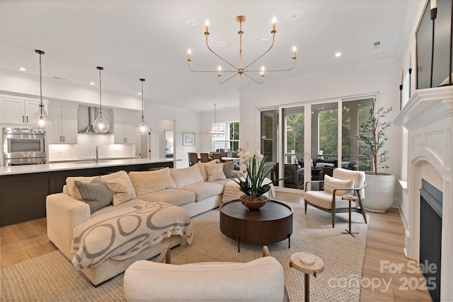 8283 Long Island Rd, Catawba, NC 28609 - living area featuring light wood-style floors, recessed lighting, a fireplace, a chandelier, and crown molding