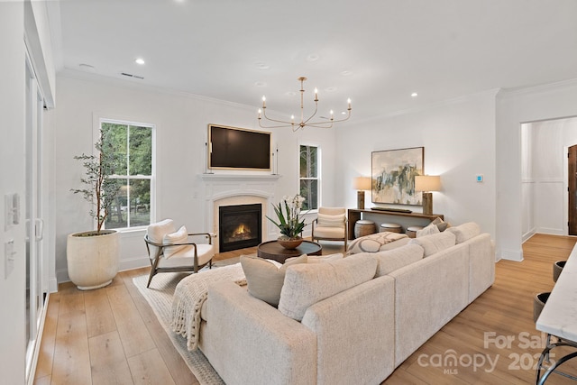 8283 Long Island Rd, Catawba, NC 28609 - living area with a glass covered fireplace, ornamental molding, a chandelier, light wood finished floors, and recessed lighting