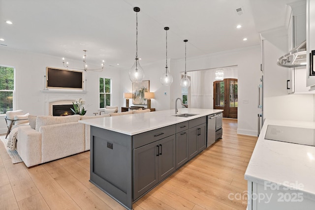 8283 Long Island Rd, Catawba, NC 28609 - kitchen with gray cabinetry, dishwasher, light wood-style flooring, recessed lighting, and a lit fireplace