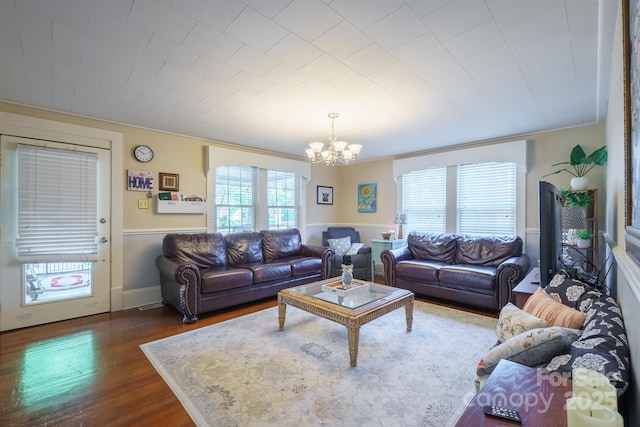 153 S Center St, Taylorsville, NC 28681 - living room featuring a chandelier, dark wood-type flooring, and wainscoting