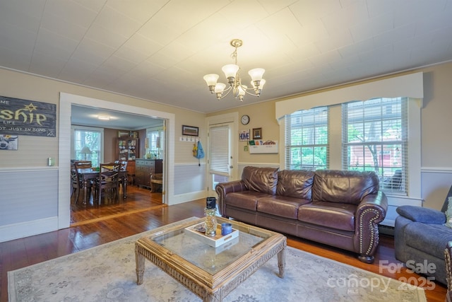 153 S Center St, Taylorsville, NC 28681 - living room with a chandelier, wood finished floors, baseboards, and a wainscoted wall
