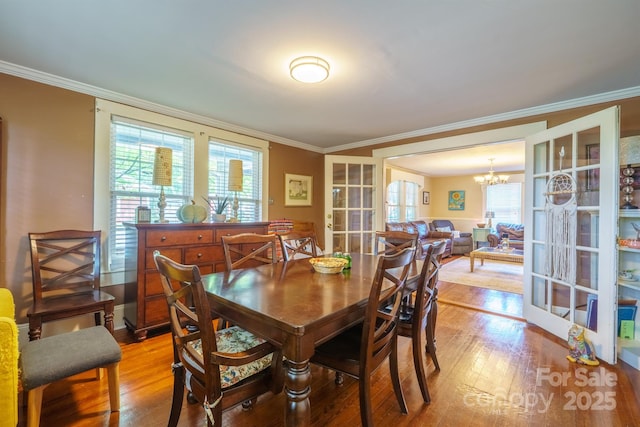 153 S Center St, Taylorsville, NC 28681 - dining space with a chandelier, crown molding, and light wood-style flooring