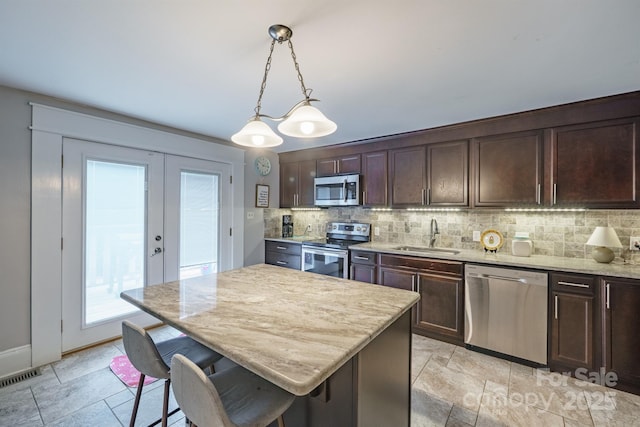 153 S Center St, Taylorsville, NC 28681 - kitchen with appliances with stainless steel finishes, a sink, backsplash, and dark brown cabinetry