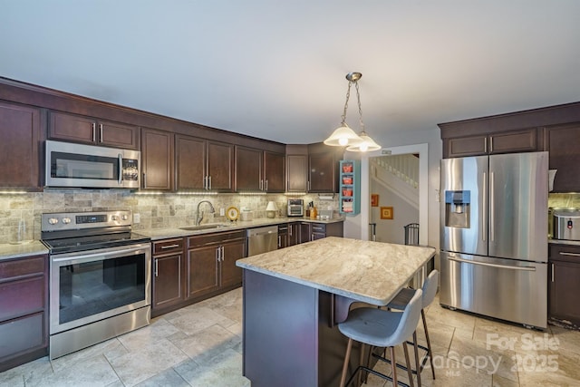 153 S Center St, Taylorsville, NC 28681 - kitchen with stainless steel appliances, a sink, tasteful backsplash, and light stone finish flooring