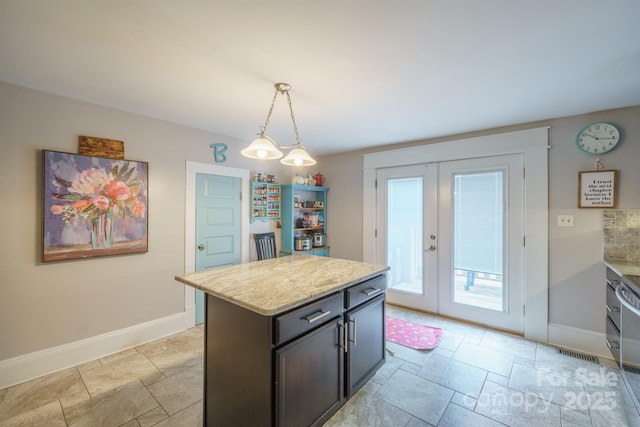 153 S Center St, Taylorsville, NC 28681 - kitchen with baseboards, french doors, hanging light fixtures, and stone tile floors
