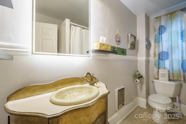 153 S Center St, Taylorsville, NC 28681 - bathroom with vanity, toilet, heating unit, tile patterned floors, and baseboards