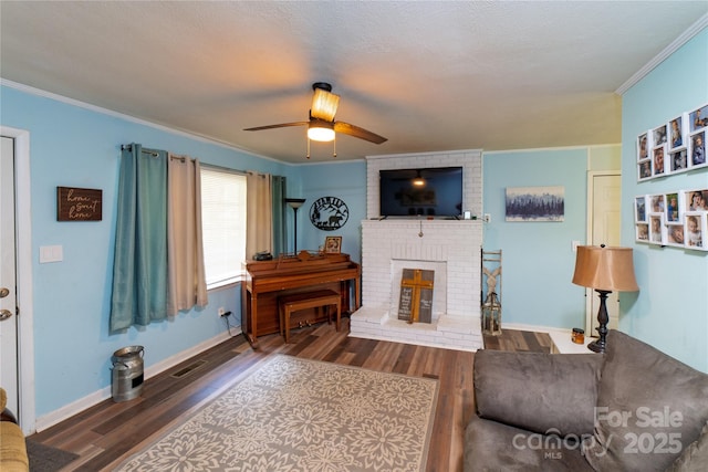 86 Pine Grove Dr, Andrews, NC 28901 - living area with wood finished floors, crown molding, ceiling fan, and a fireplace