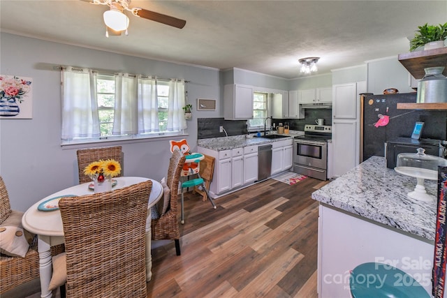 86 Pine Grove Dr, Andrews, NC 28901 - kitchen with stainless steel appliances, crown molding, dark wood finished floors, tasteful backsplash, and a ceiling fan