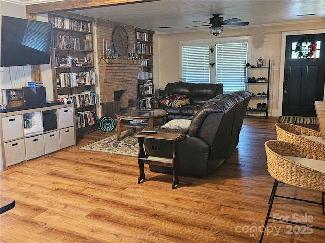 180 Vance Price Rd, Forest City, NC 28043 - living room with ceiling fan, a fireplace, wood finished floors, and crown molding